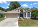 Charming single-Gathering home with a two-car garage, beautiful landscaping, and a covered front entry at 1021 Piedmont Oaks Dr, Apopka, FL 32703