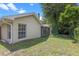 Home's exterior with a screened lanai, lush trees, and partial view of the yard at 1021 Piedmont Oaks Dr, Apopka, FL 32703