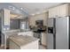 Modern kitchen with granite countertops, stainless steel appliances, and ample cabinet space at 1021 Piedmont Oaks Dr, Apopka, FL 32703