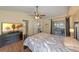 Serene bedroom with access to outdoor patio, ensuite bathroom, and dark wood furnishings at 1021 Piedmont Oaks Dr, Apopka, FL 32703