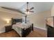 Relaxing bedroom with a ceiling fan, natural light, and wood-look tile flooring at 1021 Piedmont Oaks Dr, Apopka, FL 32703