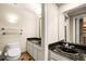 Elegant bathroom with a dark granite countertop, tiled floors, and a modern sink at 1055 Kensington Park Dr # 203, Altamonte Springs, FL 32714