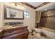 Vintage-style bathroom with a marble-top vanity and ornate framed mirror at 1055 Kensington Park Dr # 203, Altamonte Springs, FL 32714