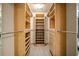 Well-organized walk-in closet with custom shelving, drawers, and rods for ample storage at 1055 Kensington Park Dr # 203, Altamonte Springs, FL 32714