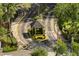 Aerial of gated community entrance with security booth, manicured landscaping, and US flag at 1055 Kensington Park Dr # 203, Altamonte Springs, FL 32714