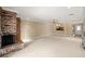Expansive living room features a brick fireplace, plush carpeting, and a convenient wet bar area at 1055 Kensington Park Dr # 203, Altamonte Springs, FL 32714