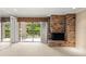 Open concept living room with brick fireplace and sliding doors leading to the balcony at 1055 Kensington Park Dr # 203, Altamonte Springs, FL 32714
