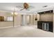 Open-concept living room featuring a wet bar, ceiling fan, and seamless flow for entertaining and relaxation at 1055 Kensington Park Dr # 203, Altamonte Springs, FL 32714