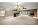 Bright living area with mirrored walls, a wet bar, and a cozy brick fireplace creates an inviting space at 1055 Kensington Park Dr # 203, Altamonte Springs, FL 32714