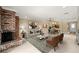 Open-concept living room featuring a brick fireplace, dining area, and modern decor at 1055 Kensington Park Dr # 203, Altamonte Springs, FL 32714
