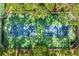 Aerial view of community tennis courts surrounded by mature trees and green spaces at 1055 Kensington Park Dr # 203, Altamonte Springs, FL 32714