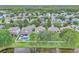 Overhead view showing backyard pools, landscaping, and lake access in a peaceful residential neighborhood at 1067 Chatham Break St, Orlando, FL 32828