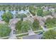 Aerial view of a residential street, lined with landscaped homes and mature trees, near a lake at 1067 Chatham Break St, Orlando, FL 32828