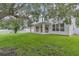 The backyard includes manicured grass, a patio, a white picket fence, and mature trees at 1067 Chatham Break St, Orlando, FL 32828