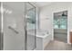Bathroom featuring a walk-in shower, soaking tub, and natural light from a window at 1067 Chatham Break St, Orlando, FL 32828