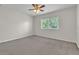 A carpeted bedroom featuring a ceiling fan and a window at 1067 Chatham Break St, Orlando, FL 32828