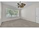 Bright bedroom featuring a ceiling fan, a window with blinds, and neutral-colored walls at 1067 Chatham Break St, Orlando, FL 32828