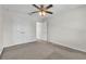 A bedroom featuring neutral walls, ceiling fan, and a closet with a full-length double doors at 1067 Chatham Break St, Orlando, FL 32828