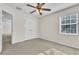 Carpeted bedroom features a ceiling fan, closet, and natural light from the window at 1067 Chatham Break St, Orlando, FL 32828