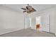 Bright bedroom featuring carpeted floor, ceiling fan, and view into the Primary bathroom at 1067 Chatham Break St, Orlando, FL 32828