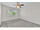 A carpeted bedroom featuring a ceiling fan and a bright window at 1067 Chatham Break St, Orlando, FL 32828