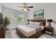 Bedroom featuring ceiling fan, large window, and stylish decor at 1067 Chatham Break St, Orlando, FL 32828