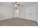 Carpeted bedroom with closet doors, ceiling fan, and a doorway at 1067 Chatham Break St, Orlando, FL 32828
