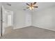 A carpeted bedroom with ceiling fan, a closet, and bright windows at 1067 Chatham Break St, Orlando, FL 32828