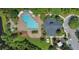 Aerial image showing a large community pool, clubhouse, and surrounding green spaces and parking at 1067 Chatham Break St, Orlando, FL 32828