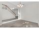 Spacious, empty room with stairs, carpet and tile flooring, and chandelier at 1067 Chatham Break St, Orlando, FL 32828
