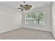 A bright empty room featuring carpet, large window and a modern fan at 1067 Chatham Break St, Orlando, FL 32828