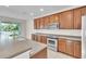 Bright kitchen featuring stainless steel appliances, ample countertop space, and backyard views at 1067 Chatham Break St, Orlando, FL 32828