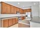 Bright kitchen with stainless steel appliances, wood cabinets, and ample countertop space at 1067 Chatham Break St, Orlando, FL 32828