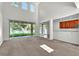 Bright living room featuring high ceilings and large windows providing natural light at 1067 Chatham Break St, Orlando, FL 32828