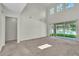 Bright living room featuring high ceilings and large windows overlooking the yard at 1067 Chatham Break St, Orlando, FL 32828
