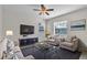 Comfortable living room with stylish furniture, a modern TV, and natural light through windows at 1067 Chatham Break St, Orlando, FL 32828