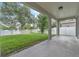 Covered patio with views of the landscaped backyard, white picket fence, and a lake at 1067 Chatham Break St, Orlando, FL 32828