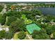 Beautiful aerial view of community tennis courts, lake and lush landscaping at 111 Woodstream Ct Ct, Maitland, FL 32751