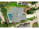 Aerial shot showcasing a home with a screened-in pool, manicured landscaping, and a stone driveway at 111 Woodstream Ct Ct, Maitland, FL 32751