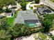 Aerial view of the home with a screened-in pool, surrounded by lush greenery and mature trees at 111 Woodstream Ct Ct, Maitland, FL 32751