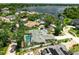 Aerial view featuring a home with a screened-in pool and surrounded by a lush landscape near the water at 111 Woodstream Ct Ct, Maitland, FL 32751