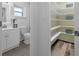 The bathroom features a vanity, toilet and linen shelves with wood floors and light green walls at 111 Woodstream Ct Ct, Maitland, FL 32751