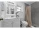 Bright bathroom features a shower with gray tiling, a window and a modern vanity with lighting at 111 Woodstream Ct Ct, Maitland, FL 32751