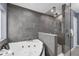 This modern bathroom features a jetted tub and glass shower with gray tiling at 111 Woodstream Ct Ct, Maitland, FL 32751