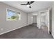 A comfortable bedroom with a ceiling fan, plush carpeting, a mirrored closet, and bright natural light at 111 Woodstream Ct Ct, Maitland, FL 32751