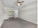 Bedroom features a ceiling fan, gray carpet, and a sliding door mirrored closet at 111 Woodstream Ct Ct, Maitland, FL 32751