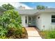 Inviting front entrance with brick accents, double doors, and vibrant landscaping creates a warm welcome at 111 Woodstream Ct Ct, Maitland, FL 32751