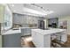 Well-lit kitchen features an island with seating, stainless steel appliances, gray cabinets, and modern countertops at 111 Woodstream Ct Ct, Maitland, FL 32751