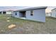 An ample backyard has a gray house and sunset on the horizon at 1147 Pomelo St, Davenport, FL 33837