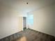 This bedroom features neutral paint, a window for natural light, and plush gray carpeting at 1147 Pomelo St, Davenport, FL 33837